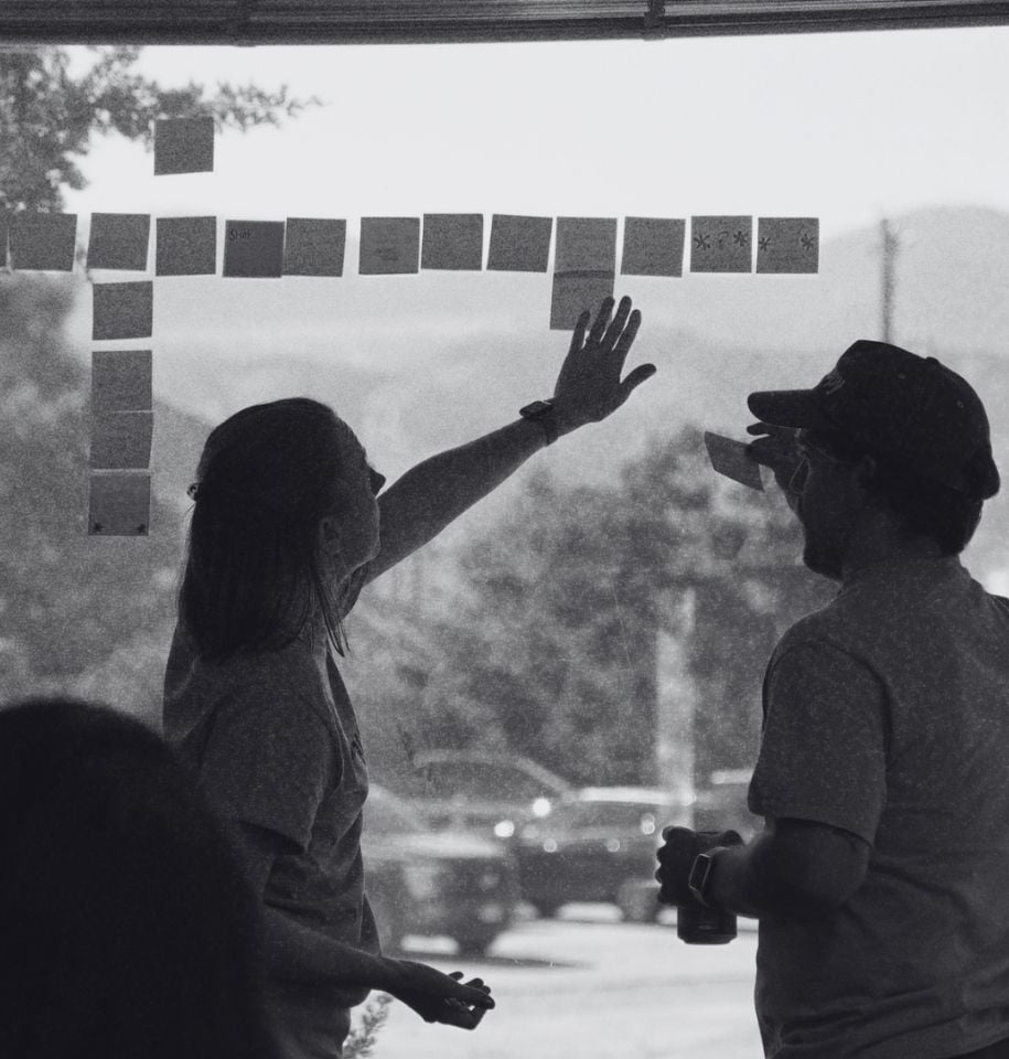 Builder Funnel team organizing sticky notes while planning a marketing workflow. Builder Funnel team organizing sticky notes while planning a marketing workflow.