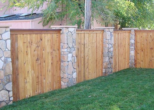 Light cedar fence with brick accents by Split Rail Fence in Denver